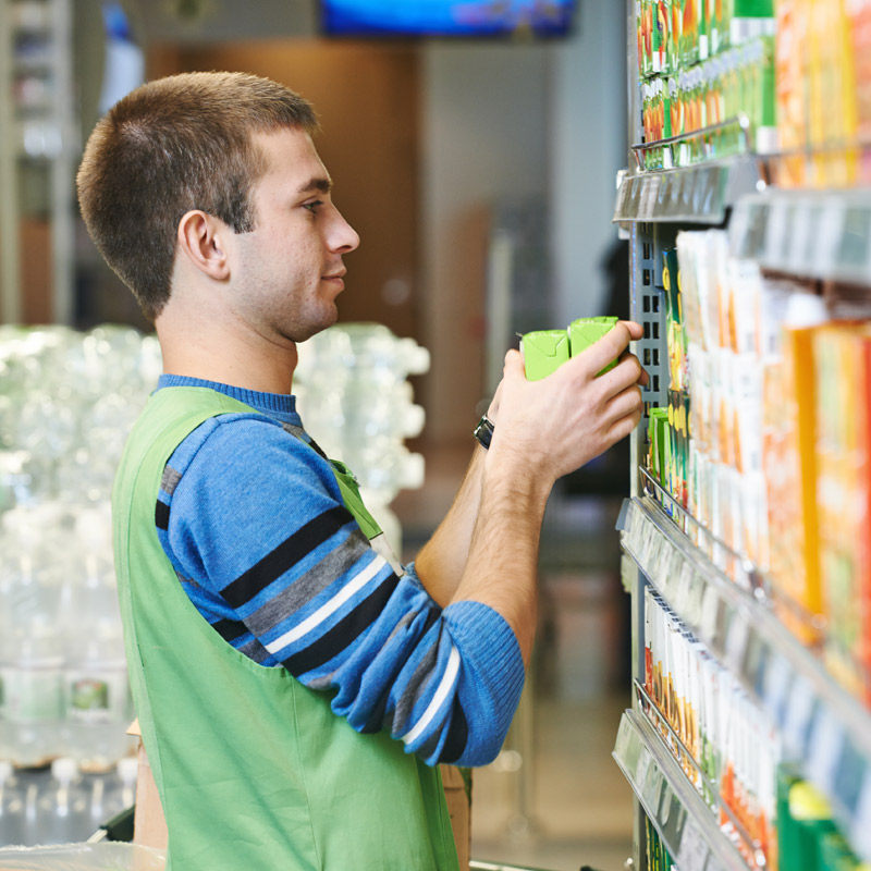Merchandising-Mitarbeiter bei der Regalverräumung im Supermarkt